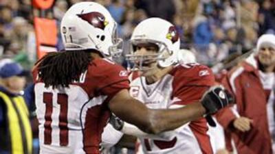 The Arizona Cardinals' Larry Fitzgerald and the quarterback Kurt Warner celebrate a touchdown against the Carolina Panthers.