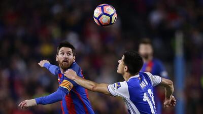 Barcelona’s Lionel Messi, left, duels for the ball against Real Sociedad’s Yuri Berchiche. Manu Fernandez / AP Photo