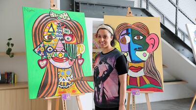 Namrata Pagarani, an artist with special needs, with two of her paintings. Pawan Singh / The National