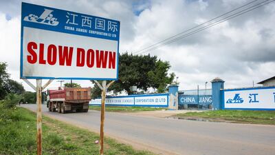 A Chinese road sign stands outside the China Jiangxi Corporation construction site in Lusaka, Zambia. Most of the digital infrastructure projects like airport terminals and highways are being built and financed by China, putting the country at what the International Monetary Fund calls a 'high' risk of debt distress. Waldo Swiegers / Bloomberg