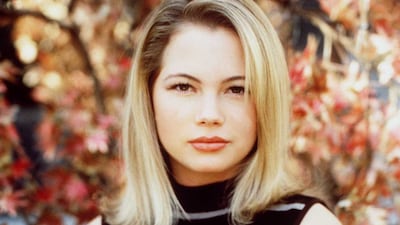 Michelle Williams, in a black striped top, poses for a headshot for her announcement as a 'Dawson's Creek' cast member in 1997. Getty Images