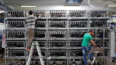 Employees work on bitcoin mining computers at a factory in Florence, While this operation is legal, hackers are now putting malicious software on victim's devices that makes them mine for digital money. Alessandro Bianchi / Reuters