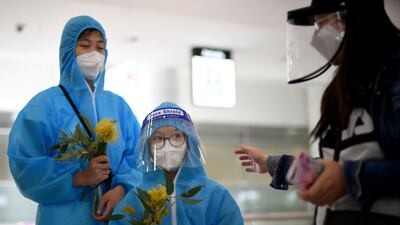 Travellers from Vietnam wearing personal protective equipment at Sydney's international airport following their arrival. AFP