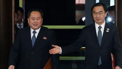 South Korea's unification minister Cho Myung-gyun, right, and North Korean chief delegate Ri Son-gwon walk into a conference hall to exchange joint statements during their meeting. AFP