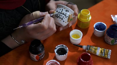 A Palestinian woman makes decorations ahead of the weekend. AFP