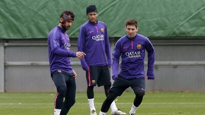 Barcelona's Martin Montoya controls the ball next to teammates Neymar and Lionel Messi on Saturday during a team training session ahead of Sunday's Real Madrid match. Gustau Nacarino / Reuters