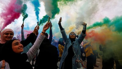 Iraqi women wave colored smoke candles during the festival of colors, in the holy Shi'ite city of Najaf, Iraq January 15, 2020. Reuters