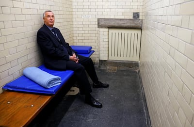 Philip Gough, a former police inspector who worked at the police station between 1989 and 1992, poses for a photograph in a cell at the Bow Street Police Museum. Reuters/John Sibley