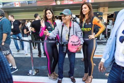 A race fan pictured with promotional staff at theYas Marina Circuit.Christopher Pike / The National