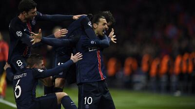Paris Saint-Germain's Swedish forward Zlatan Ibrahimovic (R) celebrates with teammates after scoring a goal during the Champions League round of 16 first leg football match between Paris Saint-Germain (PSG) and Chelsea FC on February 16, 2016, at the Parc des Princes stadium in Paris. AFP PHOTO / FRANCK FIFE