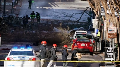 Investigators walk near the scene of an explosion in Nashville, Tenn. The explosion that shook the largely deserted streets of downtown Nashville early Christmas morning shattered windows, damaged buildings and left several people wounded. Authorities said they believed the blast was intentional. AP