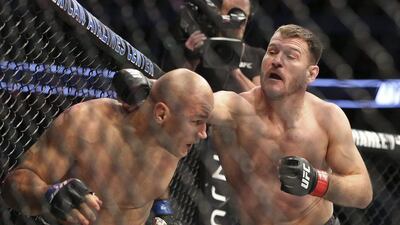 Stipe Miocic, right, lands a punch against Junior Dos Santos in a mixed martial arts bout at UFC 211 for the UFC heavyweight championship, Saturday, May 13, 2017, in Dallas. Miocic retained his heavyweight title. Gregory Payan / AP Photo