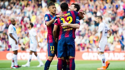 Barcelona's Lionel Messi celebrates with his teammates Rafinha and Neymar on Saturday in the final match of the La Liga season. Alex Caparros / Getty Images