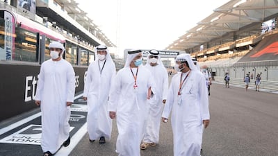 Sheikh Saif bin Zayed, Deputy Prime Minister and Minister of Interior (C), walks the pit lane prior to the Etihad Airways Abu Dhabi Grand Prix at Yas Marina Circuit. Hamad Al Kaabi / Ministry of Presidential Affairs