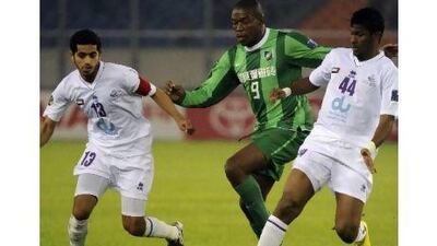 Hangzhou Greentown's Luis Ramirez, centre, is challenged by Rami Yaslam, left, and Fares Juma. AFP