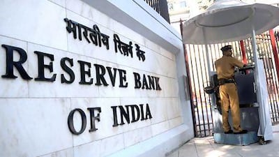 A policeman stands guard outside the head office of the Reserve Bank of India in Mumbai. Indian policymakers are looking increasingly panicky as they battle the worst currency crisis in over two decades. Punit Paranjpe / AFP