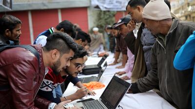 Political party agents help voters find their serial number and voting center during the general election in Dhaka. Reuters