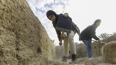 Sara Al Hameli, left, and Mai Al Mansouri Zayed University students interning with the Abu Dhabi Tourism & Culture Authority, TCA, excavate a portion of the Bayt Bin Hadi archeological site in the Hili Oasis area of Al Ain. Christopher Pike / The National