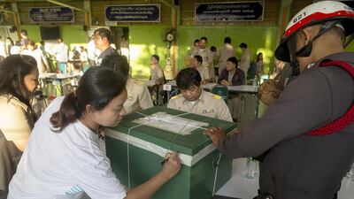 Government employees and police secure a ballot box from a referendum on a draft constitution on August 7, 2016 in Bangkok, Thailand. Brent Lewin / Getty Images