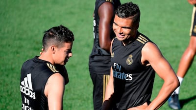 James Rodriguez, left, talks with Casemiro during training session. AFP
