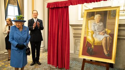 Queen Elizabeth looks at a new painting by BP Portrait Award 2017 winner, Benjamin Sullivan. The portrait was commissioned to celebrate 100 years of the RAF Club, in 2018. Getty Images