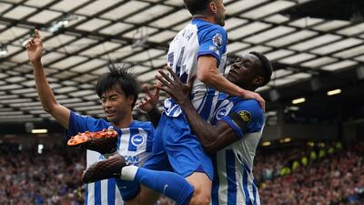Brighton and Hove Albion's Danny Welbeck celebrates with Adam Lallana, centre, and Kaoru Mitoma, left, after scoring their first goal. PA