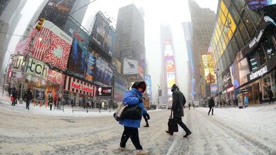 Pedestrians at Times Square during a snow storm in New York, yesterday. Emmanuel Dunand / AFP Photo