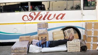 A labour rests with cargo on a pavement in Calcutta. Piyal Adhikary / EPA