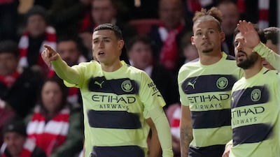 Manchester City's Phil Foden, left, celebrates with his teammates after scoring his side's opening goal. AP Photo