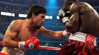 Manny Pacquiao of the Philippines throws a left to the body of Joshua Clottey of Ghana during the WBO welterweight title fight at Cowboys Stadium in Arlington, Texas.