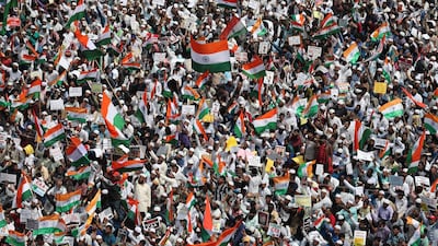 Indians hold national flags and placards during a protest organized by several Muslim organizations against a new citizenship law that opponents say threatens India's secular identity in Bangalore, India. AP