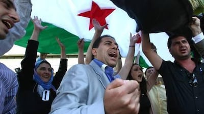 Members of the Syrian opposition shout slogans against President Bashar al Assad after their meetings in the Turkish coastal city of Antalya yesterday.
