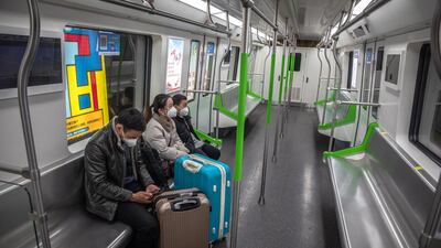 People wearing protective face masks ride in a subway in Wuhan, China. EPA