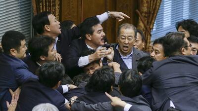 Masahisa Sato, centre, deputy chairman of the upper chamber special committee on security legislation, call for Japanese politicians to stand up for yes to pass a security bill. Kimimasa Mayama / EPA