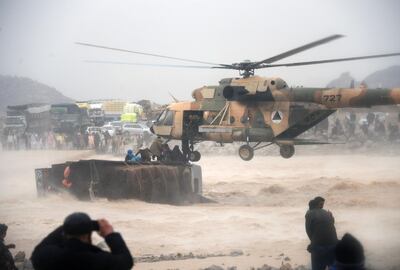An Afghan military helicopter rescues people from an overturned truck in a flooded area of Arghandab district in Kandahar province. AFP