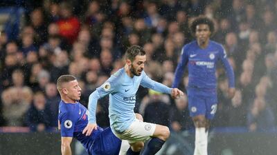 Manchester City's Bernardo Silva, right, is tackled by Chelsea's Ross Barkley during the Premier League match at Stamford Bridge. AP Photo