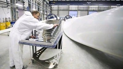An employee selects a component for a wind turbine blade at the Vestas blade factory in Lem, Denmark.