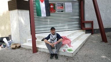 Dutch artist Dries Verhoven sits at the entrance to the Dutch Pavilion, closed to the public due to a pro-Palestine strike at the 61st Venice Art Biennale. EPA