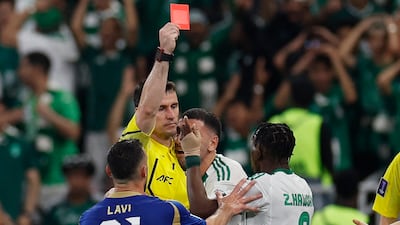 Al Ahli's Zakaria Al Hawsawi is shown a red card by referee Ilgiz Tantashev. Reuters