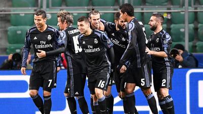 Gareth Bale is congratulated by teammates after opening the scoring for Real Madrid against Legia Warsaw. Bartlomiei Zborowski / EPA
