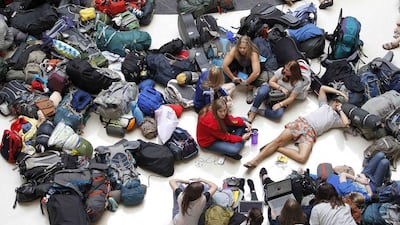Members of the mission group Adventures In Missions wait to find out if their flight to Guatemala is on time or cancelled. Tami Chappell / Reuters