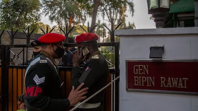Military police personnel stand outside Gen Rawat's residence. AP Photo