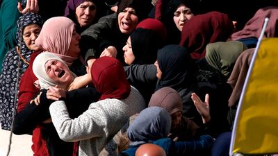 The mother (L) of 17-year-old Palestinian Ayman Hamed, who was fatally shot by Israeli troops a day earlier, mourns during his funeral in the village of Silwad. AFP