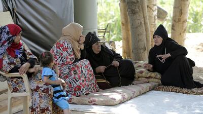 Syrian refugee women sit on mats talking at an unofficial camp for refugees in the village of Bar Elias in the Bekaa Valley in central Lebanon (AFP PHOTO / JOSEPH EID)