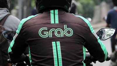 A Grab Bike driver rides on his motorbike in Jakarta, Indonesia. Grab's listing on a US market through a merger with a 'blank cheque' will include fresh funding from investors such as Blackrock, Fidelity International, Janus Henderson Investors and Singaporean sovereign fund Temasek Holdings. AP Photo