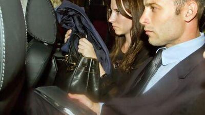 Oscar Pistorius leaves the Pretoria magistrate's court with his his sister Aimee Pistorius on Friday.