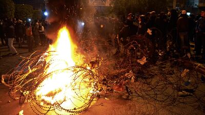 Lebanese protesters burn garbage and tires during a protest against strict lockdown measures in Tripoli, north Lebanon. AP