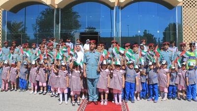 Fujairah Police and schoolchildren celebrate UAE Flag Day. Courtesy Fujairah Police.
