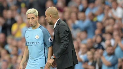 Pep Guardiola talks to Manchester City midfielder Samir Nasri ahead of his appearance from the bench. Oli Scarff / AFP