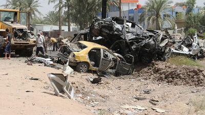 Iraqis inspect the damage at the site of a suicide bomb attack in Khales, a town about 80 kilometres north east of Baghdad. Youis Al Bayati / AFP Photo